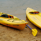 two yellow kayaks on beach